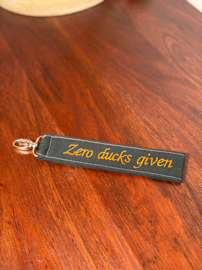 Handy-/Schlüsselhandschlaufe inkl. Handyhalterung - "Zero ducks given"